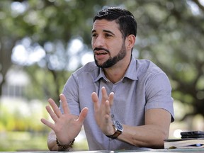 In this photo taken Wednesday, Nov. 8 2017, Javier Gonzalez talks to a reporter in Hialeah, Fla. Gonzalez has joined the tens of thousands of Puerto Ricans moving to Florida after Hurricane Maria, grateful for a place to start over but not without resentment over how his island was treated in the disaster. (AP Photo/Alan Diaz)
