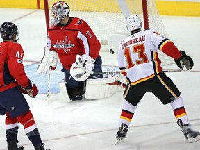 Johnny Gaudreau of the Calgary Flames scores past Braden Holtby of the Washington Capitals during NHL action Monday night in Washington. Gaudreau extended his points streak to 10 straight games as the Flames posted a 4-1 victory.