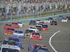 Drivers make their way at the start of the NASCAR Xfinity Series auto race at Homestead-Miami Speedway in Homestead, Fla., Saturday, Nov. 18, 2017. (AP Photo/Gaston De Cardenas)