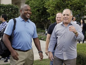 Michael Hill, left, president of baseball operations for the Miami Marlins and Al Avila, right, executive vice president of baseball operations and general manager of the Detroit Tigers greet members of the media at the annual MLB baseball general managers' meetings, Tuesday, Nov. 14, 2017, in Orlando, Fla. (AP Photo/John Raoux)
