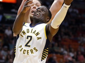 Indiana Pacers guard Darren Collison (2) goes to the basket as Miami Heat center Kelly Olynyk (9) defends in the first quarter of an NBA basketball game, Sunday, Nov. 19, 2017, in Miami. (AP Photo/Joe Skipper)