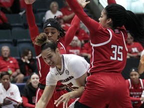 South Carolina's Alexis Jennings, center is fouled as Rutgers' Khadaizha Sanders, left, and Rutgers' Stasha Carey (35) defend during the first quarter of an NCAA college basketball game in the Gulf Coast Showcase tournament, Friday, Nov. 24, 2017, in Estero, Fla. (AP Photo/Luis M. Alvarez)