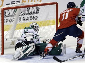 Florida Panthers' Jonathan Huberdeau (11) scores a goal against Dallas Stars goalie Kari Lehtonen (32), of Finland, during the first period of an NHL hockey game, Tuesday, Nov. 14, 2017, in Sunrise, Fla. (AP Photo/Lynne Sladky)