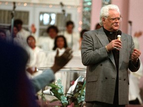 In this May 21, 1995 photo, Wayne Cochran speaks at the Voice of Jesus Christian Center in Miami. Cochran, the "blue-eyed soul" singer known for his towering pompadour, has died of cancer at his Florida home, according to his son Christopher Cochran. He was 78.  (Jeffery A. Salter/Miami Herald via AP)