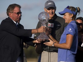 LPGA Tour pro Lexi Thompson is awarded the CME Globe season trophy after the final round of the CME Group Tour Championship at Tiburón Golf Club, Sunday, Nov. 19, 2017 in Naples, Fla.  (Luke Franke/Naples Daily News via AP)