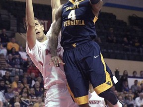 West Virginia guard Daxter Miles Jr. (4) goes up for a shot in front of Marist forward Aleksandar Dozic, left, during the first half of an NCAA college basketball game at the AdvoCare Invitational tournament Thursday, Nov. 23, 2017, in Lake Buena Vista, Fla. (AP Photo/Phelan M. Ebenhack)