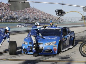 Crew members for Kyle Larson perform a pit stop during a NASCAR Cup Series auto race at Homestead-Miami Speedway in Homestead, Fla., Sunday, Nov. 19, 2017. (AP Photo/Terry Renna)