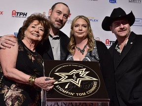 Members of Stompin' Tom Connors family including his widow Lena Connors (left) and sons Tom Jr. (second from left) and Taw Connors (right), along with Tom Jr.'s wife Jessica Roselle (second from right) unveil the late country singer's star at the Walk of Fame induction ceremony in Toronto, Wednesday, Nov.15, 2017. THE CANADIAN PRESS/Frank Gunn