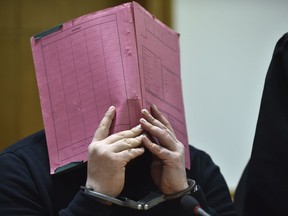 FILE - The Jan. 22, 2015 file photo shows former nurse Niels Hoegel covering his face during his trial at the regional court in in Oldenburg, northern Germany. The prosecutors in Oldenburg on Thursday, Nov. 9, 2017 said that he might have killed more than 100 people based on a toxicologic investigation. (Carmen Jaspersen/dpa via AP)