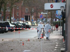 Police investigators look for traces after an apparently intoxicated man has driven a car into pedestrians in northern Germany city of Cuxhaven, Sunday morning, Nov. 26, 2017. Six people were injured. (Jens Potschka/Cuxhavener Nachrichten/dpa via AP)