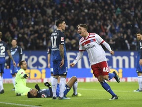 Hamburg's Jann-Fete Arp, right,  celebrates after an own goal by Hoffenheim's Kevin Akpoguma during the German Bundesliga soccer match between Hamburger SV and 1899 Hoffenheim in the Volksparkstadion in Hamburg, Germany, Sunday, Nov. 26,  2017. (Daniel Reinhardt/dpa via AP)