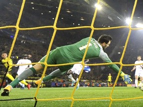 Dortmund's Pierre-Emerick Aubameyang, left, scores the opening goal past Tottenham goalkeeper Hugo Lloris during the soccer Champions League group H match between Borussia Dortmund and Tottenham Hotspur in Dortmund, Germany, Tuesday, Nov. 21, 2017. (AP Photo/Martin Meissner)