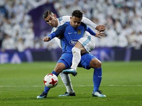 Real Madrid's Theo Hernandez, rear, vies for the ball with Fuenlabrada's Hugo Fraile during a Spanish Copa del Rey round of 32 second leg soccer match between Real Madrid and Fuenlabrada at the Santiago Bernabeu stadium in Madrid, Tuesday, Nov. 28, 2017. (AP Photo/Francisco Seco)