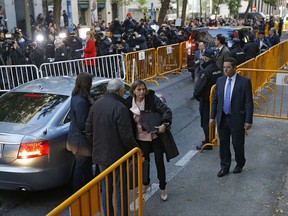 Ex-speaker of the Catalonia parliament Carme Forcadell, center, arrives at the Supreme Court in Madrid, Thursday, Nov. 9, 2017. Six Catalan lawmakers are testifying Thursday before a Spanish judge over claims that they ignored Constitutional Court orders and allowed an independence vote in Catalonia's regional parliament. (AP Photo/Francisco Seco)