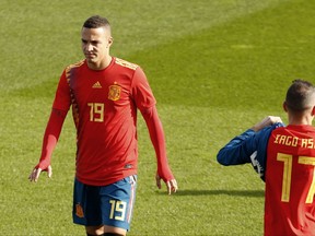 Spain's Rodrigo Moreno, wearing the new soccer kit for the 2018 World Cup, walks along the pitch with teammates during a training session in Las Rozas, outskirts Madrid, Spain, Wednesday, Nov. 8, 2017. Spain jersey's for the World Cup has sparked controversy after being linked to the Republican flag of the 1930s. The jersey has the colors red, yellow and blue but some say that from afar the blue appears to have the same purple tone of the Republican flag used from 1931-39. (AP Photo/Francisco Seco)