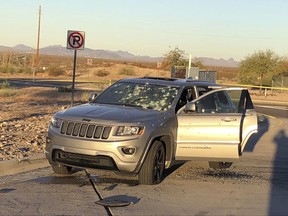 This photo provided by the Arizona Department of Public Safety shows a bullet riddled vehicle after a suspect in a Phoenix homicide was involved in a shootout with law enforcement officers at a rest area Tuesday, Nov. 28, 2017, in western Arizona. The suspect was was critically wounded. The incident at the rest area, located in the desert approximately 95 miles west of Phoenix, closed a 36-mile stretch of westbound Interstate 10 in western Arizona over five hours Tuesday morning. The roadway has since reopened.  (Arizona Department of Public Safety via AP)