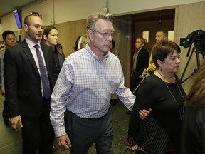 File - In this Nov. 30, 2017 file photo, Jim Steinle, center, and Liz Sullivan, right, the parents of Kate Steinle, walk to a court room for closing arguments in the trial of Jose Ines Garcia Zarate accused of killing their daughter, in San Francisco. A jury has reached a verdict Thursday, Nov. 30, 2017, in the trial of Mexican man at center of immigration debate in the San Francisco pier shooting. (AP Photo/Eric Risberg, File)
