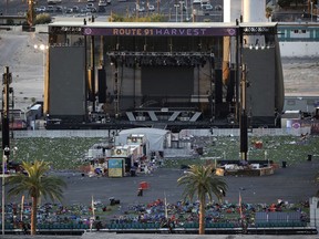 FILE - In this Oct. 3, 2017, file photo, debris litters a concert festival grounds after a mass shooting in Las Vegas. Attorneys who filed one of the first lawsuits after the Oct. 1 mass shooting that killed dozens of concert-goers on the Las Vegas Strip filed four new negligence cases Monday, Nov. 20, on behalf of more than 450 victims. (AP Photo/John Locher, File)