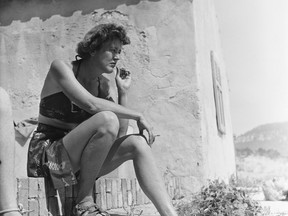 In this 1950 photo provided by Thames and Hudson, is Julia Child in Cassis, France that is part of the exhibit, "France is a Feast - The Photographic Journey of Paul and Julia Child," at the Napa Valley Museum in Yountville, Calif. The exhibit features rarely seen photographs by Paul Child taken between 1948 to 1954 when he and Julia Child lived in Paris. (Paul Child/The Schlesinger Library, Radcliffe Institute, Harvard University via AP)