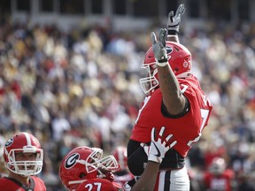 Georgia offensive guard Isaiah Wynn (77) celebrates with tailback Nick Chubb (27) after Chubb scored a touchdown in the first half of a NCAA college football game between Georgia and Georgia Tech in Atlanta, Saturday, Nov. 25, 2017. (Joshua L. Jones/Athens Banner-Herald via AP)