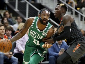 Boston Celtics' Kyrie Irving, left dribbles against Atlanta Hawks' Dennis Schroder, of Germany, in the second quarter of an NBA basketball game in Atlanta, Saturday, Nov. 18, 2017. Boston won 110-99. (AP Photo/David Goldman)