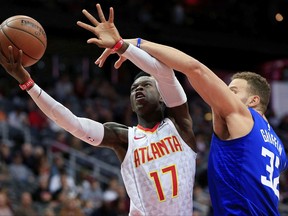 Atlanta Hawks guard Dennis Schroeder (17), of Germany, shoots next to Los Angeles Clippers forward Blake Griffin (32) during the first quarter of an NBA basketball game in Atlanta, Wednesday, Nov. 22, 2017. (AP Photo/Daniel Shirey)