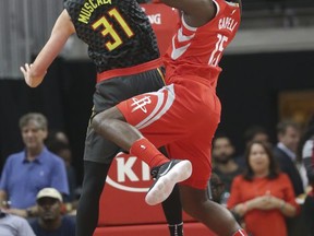 Houston Rockets center Clint Capela (15) shoots as Atlanta Hawks forward Mike Muscala (31) defends during the first half of an NBA basketball game Friday, Nov. 3, 2017, in Atlanta. (AP Photo/John Bazemore)