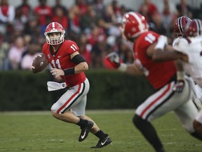 Georgia quarterback Jake Fromm (11) rolls out as he looks for an open receiver during the second half of an NCAA college football game against South Carolina Saturday, Nov. 4, 2017, in Athens, Ga. Georgia won 24-10. (AP Photo/John Bazemore)