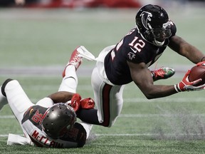 Tampa Bay Buccaneers defensive back Robert McClain (36) tackles Atlanta Falcons wide receiver Mohamed Sanu (12) during the first half of an NFL football game, Sunday, Nov. 26, 2017, in Atlanta. (AP Photo/Chris O'Meara)