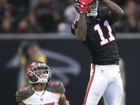 Atlanta Falcons wide receiver Julio Jones (11) makes the catch ahead of Tampa Bay Buccaneers cornerback Ryan Smith (29) during the second half of an NFL football game, Sunday, Nov. 26, 2017, in Atlanta. The Atlanta Falcons won 34-20. (AP Photo/John Bazemore)