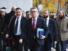 German Interior Minister, Thomas de Maiziere, of the Christian Democratic Party arrives for exploratory talks with the Free Democrats and the Greens in Berlin, Germany, Sunday, Nov. 19, 2017.