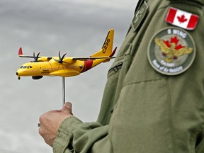 Col. Mark Goulden holds a model of a C-295W plane Wednesday, July 26, 2017 at CFB Trenton, Ont.