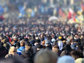 Crowd of anonymous people on street in city center