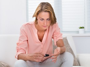 Woman Checking Blood Sugar Level