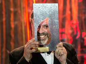 Author Michael Redhill celebrates winning the 2017 Giller Prize for his novel Bellevue Square, in Toronto on Monday, Nov. 20, 2017.