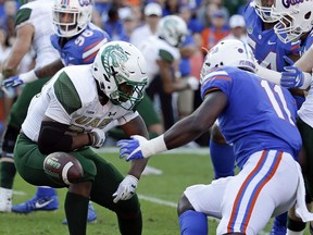 UAB running back Spencer Brown, left, fumbles the ball in front of Florida linebacker Vosean Joseph (11) during the first half of an NCAA college football game, Saturday, Nov. 18, 2017, in Gainesville, Fla. Florida recovered the fumble. (AP Photo/John Raoux)
