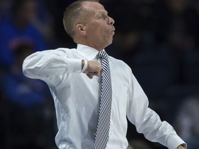 North Florida head coach Matthew Driscoll yells instructions to his team during the first half of an NCAA college basketball game against Florida in Gainesville, Fla., Thursday, Nov. 16, 2017. (AP Photo/Ron Irby)