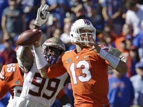 Florida State defensive end Brian Burns (99) strips the ball from the hand of Florida quarterback Feleipe Franks (13) during the first half of an NCAA college football game, Saturday, Nov. 25, 2017, in Gainesville, Fla. Florida State recovered the fumble and scored a touchdown. (AP Photo/John Raoux)