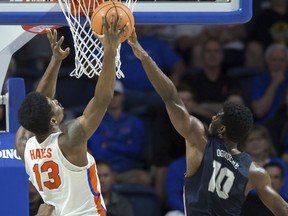 Florida forward Kevarrius Hayes' (13) shot is blocked by New Hampshire guard John Ogwuche (10) during the first half of an NCAA college basketball game in Gainesville, Fla., Sunday, Nov. 19, 2017. (AP Photo/Ron Irby)