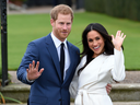 Prince Harry and Meghan Markle pose outside Kensington Palace in London, Monday Nov. 27, 2017.