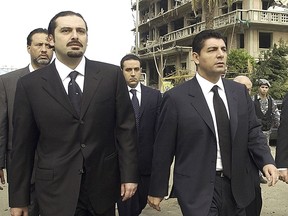 FILE - In this Feb. 19, 2005 file photo, Bahaa Hariri, right, and Saad Hariri, sons of slain Lebanese former Prime Minister Rafik Hariri, visit the scene where their father was assassinated inBeirut, Lebanon. In a statement from Bahaa Hariri's office sent to The Associated Press Wednesday, Nov. 15, 2017, Prime Minister Saad Hariri's older brother broke his silence over the prime minister's mysterious resignation, saying he supports his brother's decision. (AP photo, File)