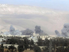 This photo provided on Nov. 17, 2017 by the Syrian anti-government activist group Ghouta Media Center, which has been authenticated based on its contents and other AP reporting, shows smoke and debris rising after Syrian government airstrikes hit in Eastern Ghouta, near Damascus, Syria. Syrian activists say at least five children have been killed in a Damascus suburb during government shelling while government media reports three civilians were killed by rebel mortars. (Ghouta Media Center via AP)