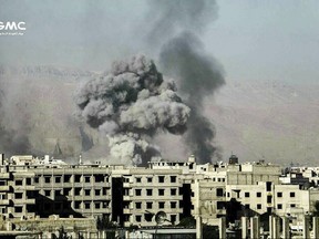 This photo provided on Nov. 16, 2017 by the Syrian anti-government activist group Ghouta Media Center, which has been authenticated based on its contents and other AP reporting, shows smoke and debris rising after Syrian government airstrikes hit in Eastern Ghouta, near Damascus, Syria. Syrian activists and a monitoring group say almost two dozen civilians have been killed in the last three days of fighting in the suburb of the capital, Damascus, along with dozens of government forces and rebels. (Ghouta Media Center via AP)