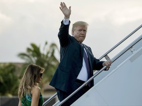 President Donald Trump and first lady Melania Trump board Air Force One at Joint Base Pearl Harbor Hickam, Hawaii, Saturday, Nov. 4, 2017, to travel to Yokota Air Base in Fussa, Japan. Trump begins a five country trip through Asia traveling to Japan, South Korea, China, Vietnam and the Philippians. (AP Photo/Andrew Harnik)