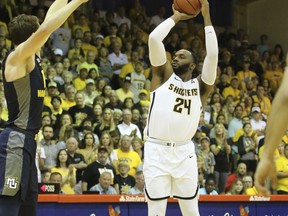 Wichita State center Shaquille Morris (24) shoots over Marquette center Matt Heldt (12) during the first half of an NCAA college basketball game, Tuesday, Nov. 21, 2017, in Lahaina, Hawaii. (AP Photo/Marco Garcia)