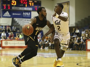 Virginia Commonwealth guard Mike'l Simms (1) tries to get past California guard Juhwan Harris-Dyson (2) during the first half of an NCAA college basketball game, Tuesday, Nov. 21, 2017, in Lahaina, Hawaii. (AP Photo/Marco Garcia)