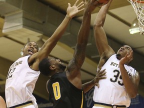 Notre Dame forwards Elijah Burns (12) and Bonzie Colson (35) defend Wichita State forward Rashard Kelly (0) during the first half of an NCAA college basketball game, Wednesday, Nov. 22, 2017, in Lahaina, Hawaii. (AP Photo/Marco Garcia)
