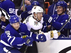 Toronto Maple Leafs defenceman Jake Gardiner (right) reacts on the bench as Ron Hainsey (left) checks Vegas Golden Knights centre Oscar Lindberg on Nov. 6.