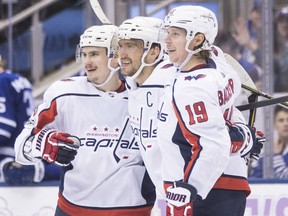 Alex Ovechkin, centre, celebrates with Washington Capitals teammates Dmitry Orlov (left) and Nicklas Backstrom after scoring against the Maple Leafs during third period action in Toronto on Saturday night.