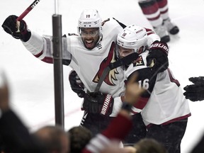 Anthony Duclair celebrates his game winning goal against the Senators with Arizona Coyotes teammate Max Domi during overtime in Ottawa on Saturday.